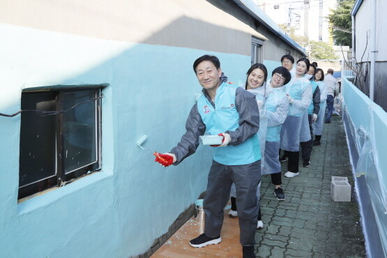 담장 도색 봉사활동 장면. 사진=건보공단 부울경본부 제공