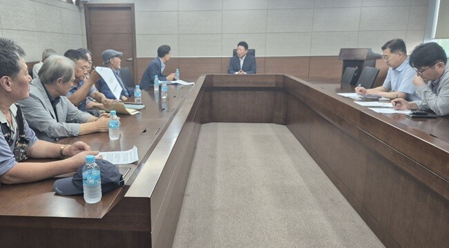 18일, 묵안리 주민들이 한전의 송전선 설계변경 추진의부당함을 서태원 군수에게 설명하고 있다. 사진=최남일 기자