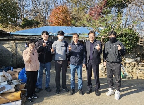 주거개선 봉사를 마친 뒤, 양평로타리클럽 민재완 회장과 회원들이 신동호 강상면장과 함께 현장에서 기념사진을 남겼다. 사진=양평로타리클럽 제공